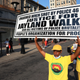 People march demanding justice for Jayland Walker on Market Street on July 15, 2022, in Newark, New Jersey. The People’s Organization for Progress (POP) organized a march and rally to demand justice for Jayland Walker, who was killed in Akron, Ohio, by police on June 27, 2022. According to a medical examiner’s report released today, Walker, who was unarmed at the time, suffered 46 gunshot wounds after multiple police officers shot at him an estimated 90 times following a car chase. The family held an open casket funeral for Walker on July 13th, and drew comparisons to a choice by Emmett Till’s mother 67 years ago that helped galvanize the national Civil Rights Movement.